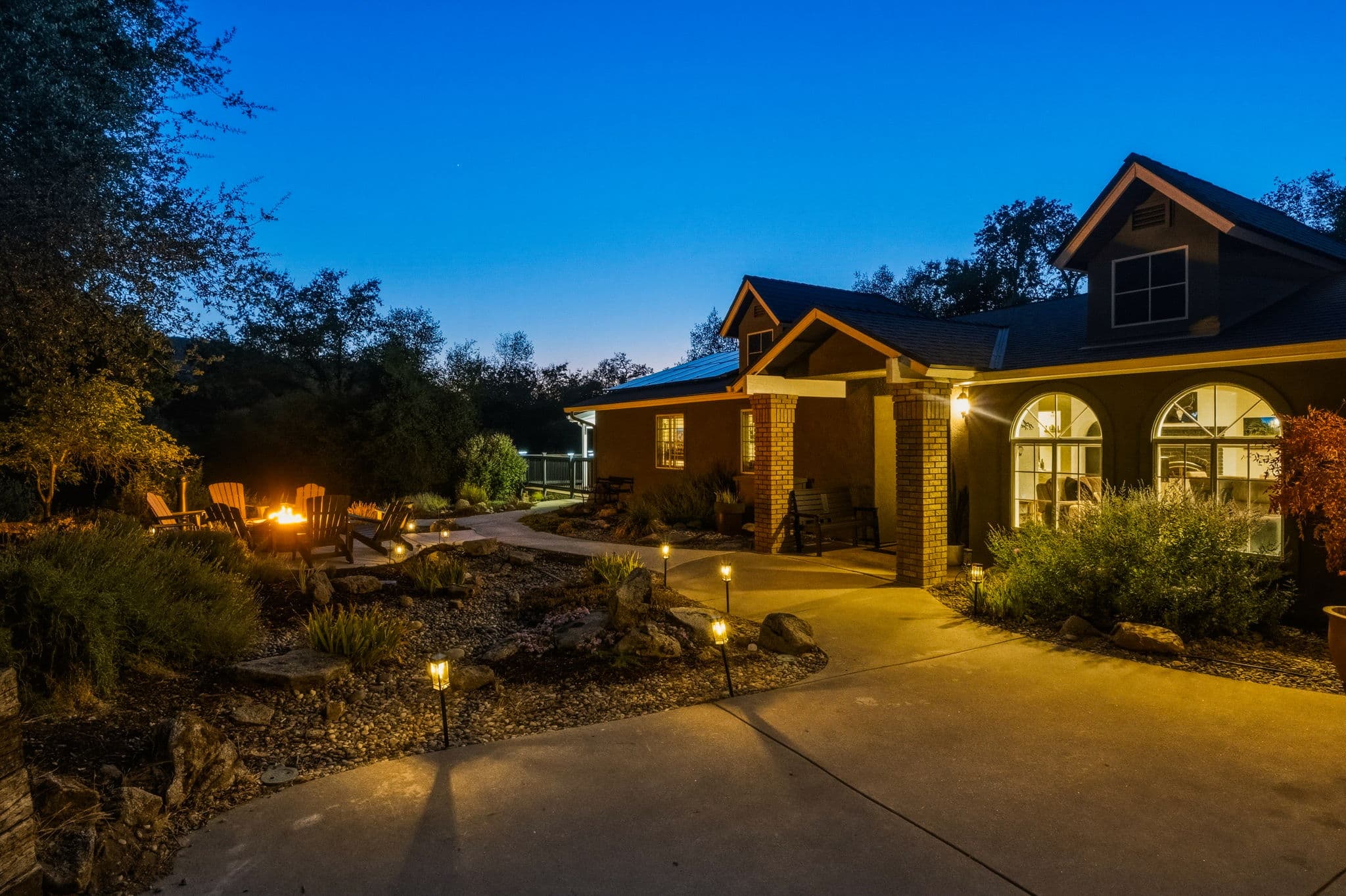 Deer Creek Retreat glowing at twilight among the Sierra trees