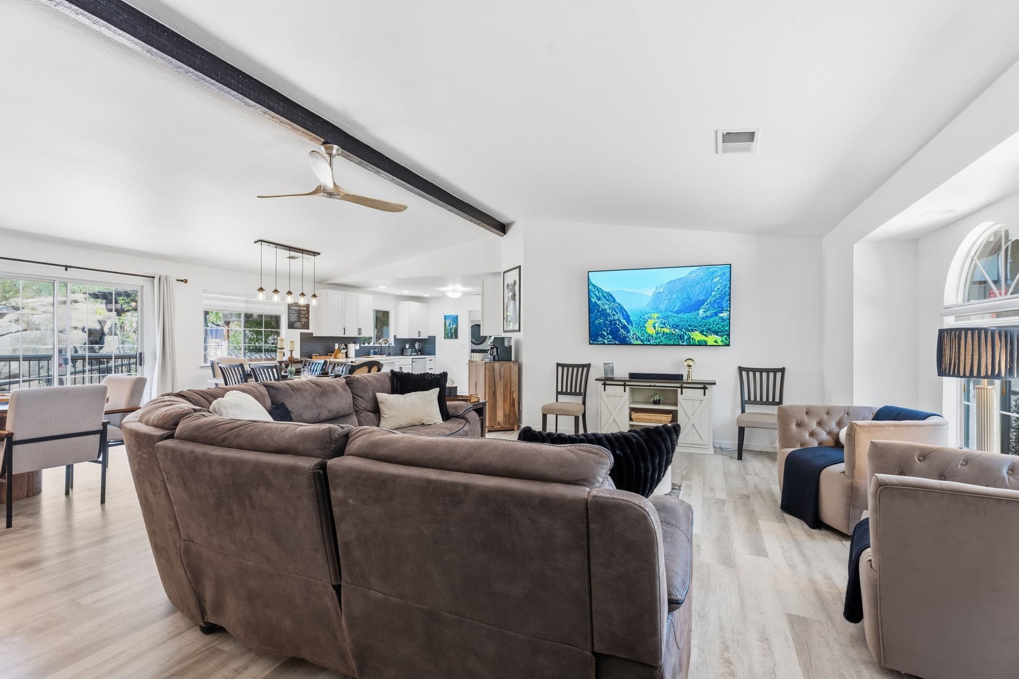 Bright open-plan living room, dining space, and kitchen