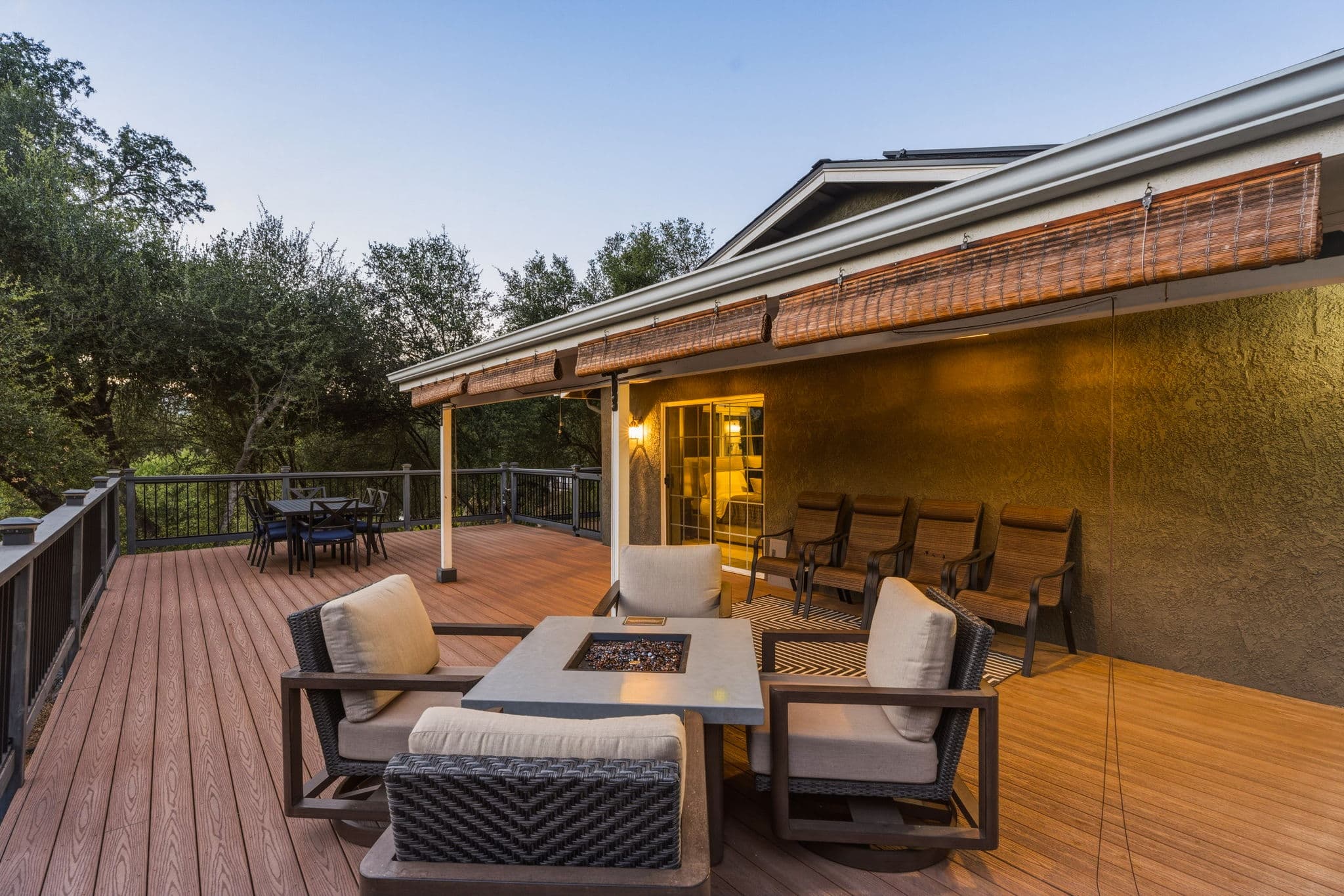 Deck seating and fire table overlooking the trees